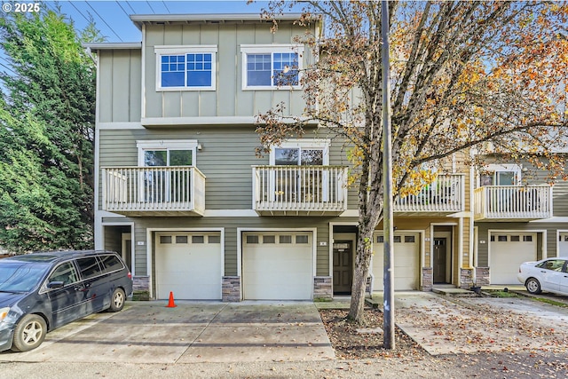 18445 SW Stepping Stone Dr Unit 16, Beaverton, OR 97003 - view of property featuring board and batten siding, driveway, a garage, and stone siding