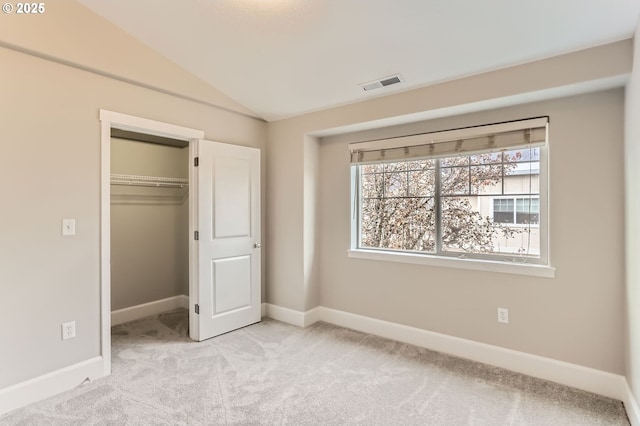 18445 SW Stepping Stone Dr Unit 16, Beaverton, OR 97003 - unfurnished bedroom with light carpet, baseboards, vaulted ceiling, and a closet