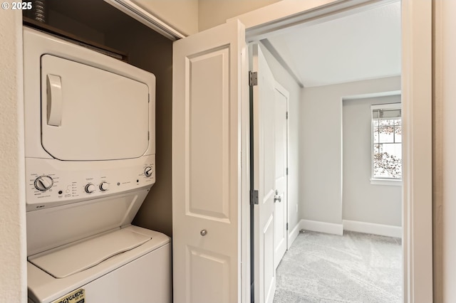 18445 SW Stepping Stone Dr Unit 16, Beaverton, OR 97003 - washroom with stacked washer / dryer, light colored carpet, and baseboards