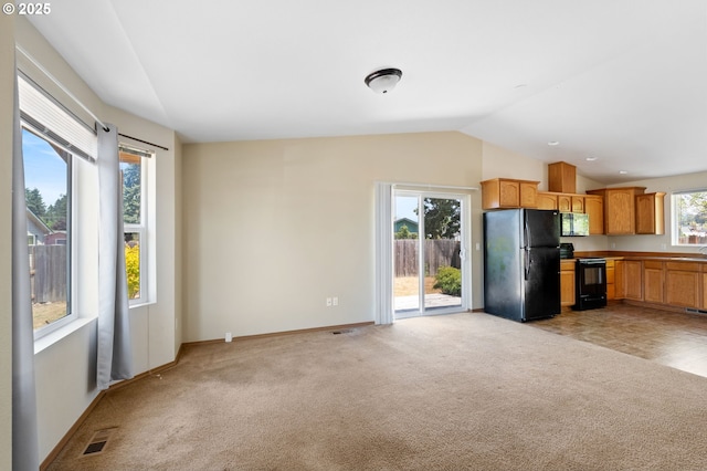 1264 Ostrander Ln, Cottage Grove, OR 97424 - kitchen featuring black appliances, light colored carpet, and vaulted ceiling