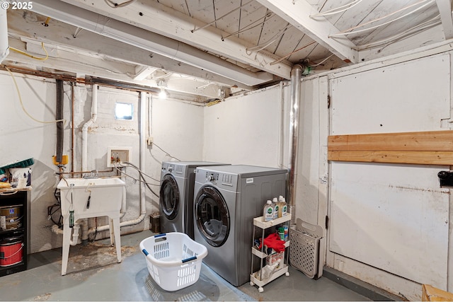 laundry room with independent washer and dryer, laundry area, and a sink