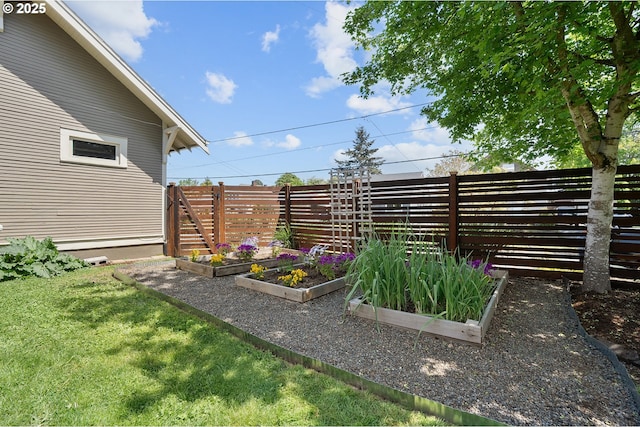view of yard featuring fence and a garden