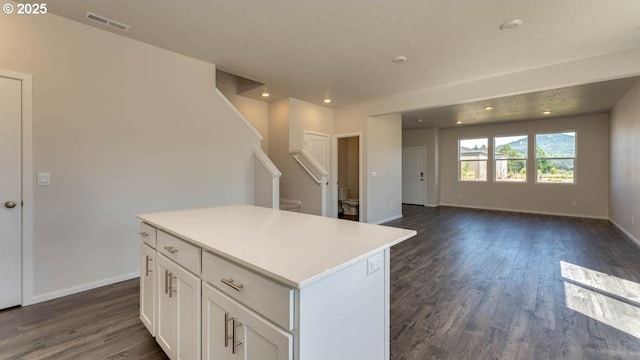 2873 V St, Springfield, OR 97477 - kitchen featuring dark wood-style floors, a kitchen island, white cabinetry, light countertops, and recessed lighting