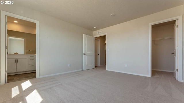 2873 V St, Springfield, OR 97477 - unfurnished bedroom featuring light colored carpet, a spacious closet, connected bathroom, and a closet