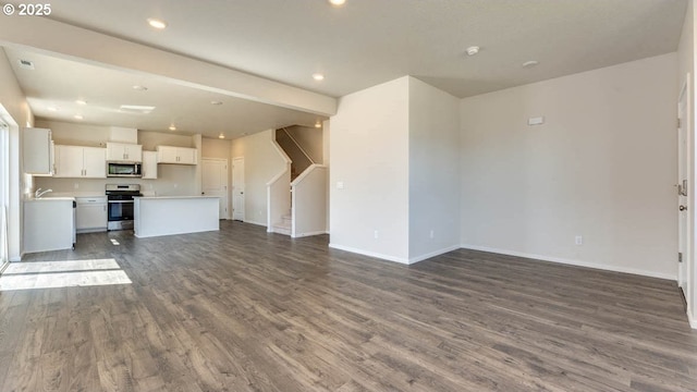 2873 V St, Springfield, OR 97477 - unfurnished living room featuring dark wood-style flooring, stairs, and recessed lighting