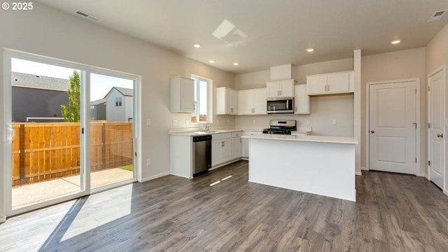 2873 V St, Springfield, OR 97477 - kitchen with stainless steel appliances, white cabinets, dark wood-style floors, light countertops, and recessed lighting