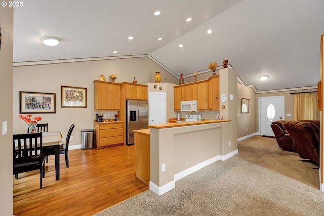 1565 Fairview Pl, Cottage Grove, OR 97424 - kitchen with stainless steel fridge, white microwave, lofted ceiling, a peninsula, and light countertops