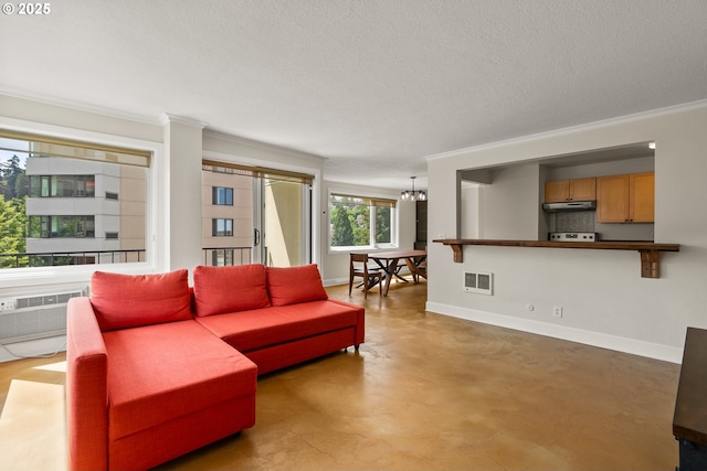 2211 SW Park Pl, Portland, OR 97205 - living area featuring a chandelier, concrete flooring, ornamental molding, a textured ceiling, and a wall unit AC