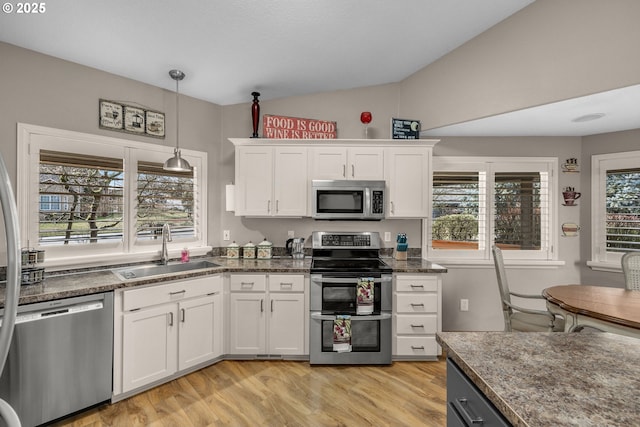 kitchen featuring stainless steel appliances, sink, and white cabinets