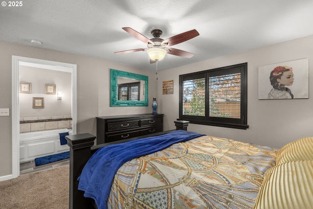 carpeted bedroom with ensuite bathroom and ceiling fan