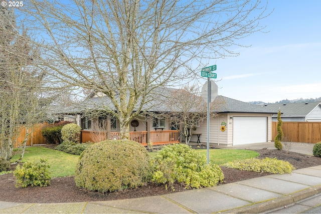 ranch-style home featuring a garage and a front yard