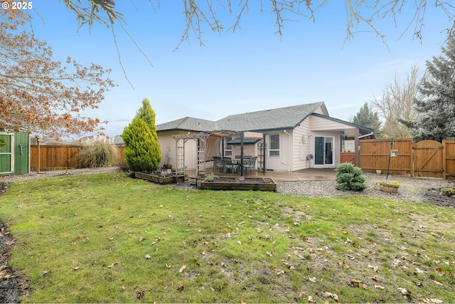 back of house featuring a patio and a lawn