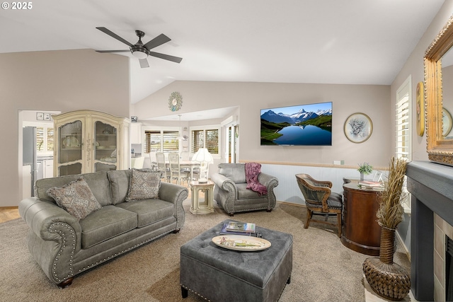 living room with vaulted ceiling, light carpet, and ceiling fan