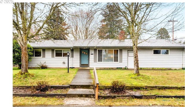 ranch-style home with a chimney and a front lawn