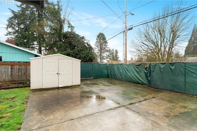 exterior space with a shed, an outdoor structure, and fence