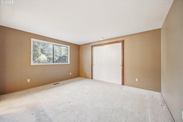 unfurnished bedroom featuring carpet and a closet