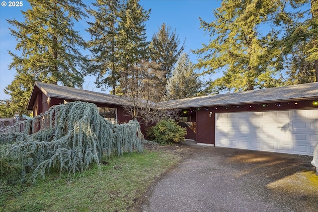 view of front of house with aphalt driveway and an attached garage