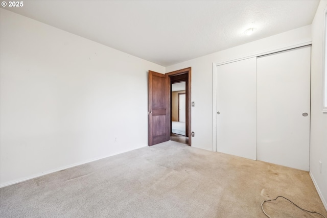 unfurnished bedroom with a closet and carpet flooring