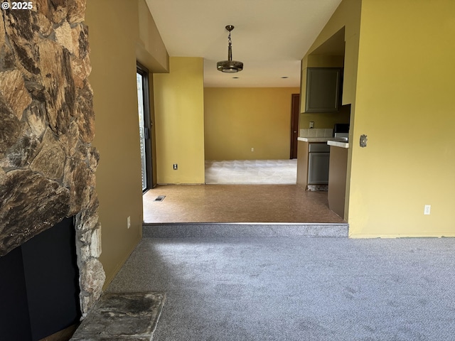 unfurnished living room with visible vents, a fireplace, and carpet floors