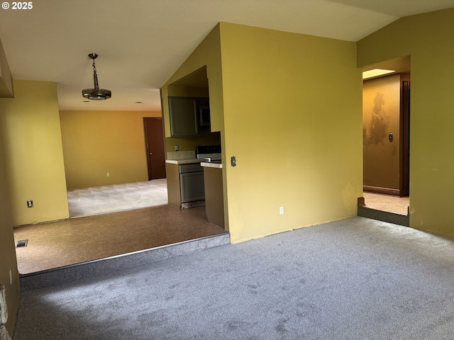 spare room with lofted ceiling and light colored carpet