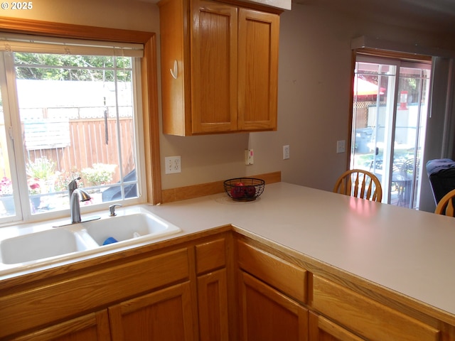 4471 Spring Meadow Ave, Eugene, OR 97404 - kitchen with a sink, light countertops, and brown cabinetry