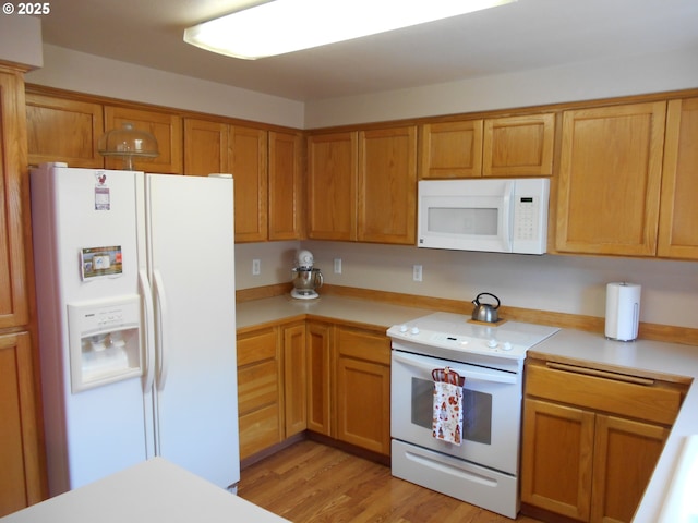 4471 Spring Meadow Ave, Eugene, OR 97404 - kitchen with white appliances, light countertops, light wood-style floors, and brown cabinets