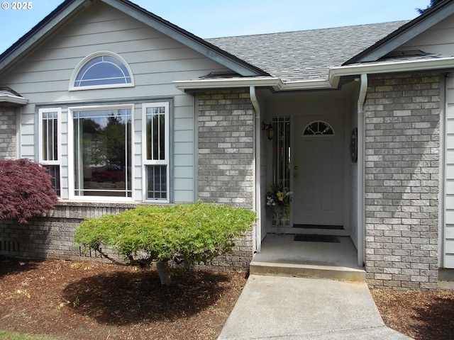 4471 Spring Meadow Ave, Eugene, OR 97404 - view of exterior entry with a shingled roof and brick siding