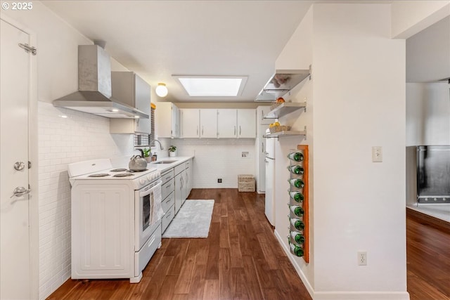 kitchen with sink, white cabinets, white electric range oven, dark wood-type flooring, and wall chimney range hood