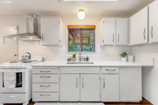 kitchen featuring white range with electric stovetop, tasteful backsplash, white cabinetry, sink, and wall chimney range hood