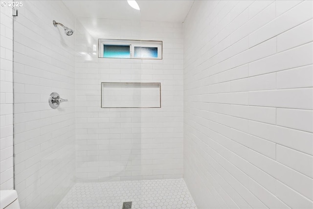 bathroom with tiled shower