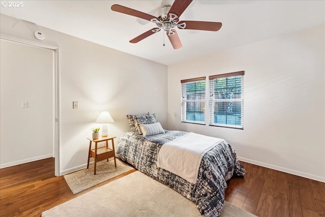 bedroom with ceiling fan and dark hardwood / wood-style flooring