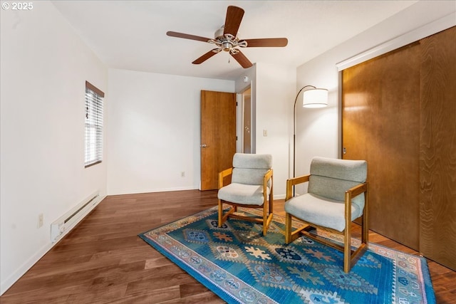 living area featuring a baseboard radiator, dark hardwood / wood-style floors, and ceiling fan