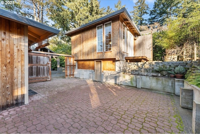 view of side of property with a patio area