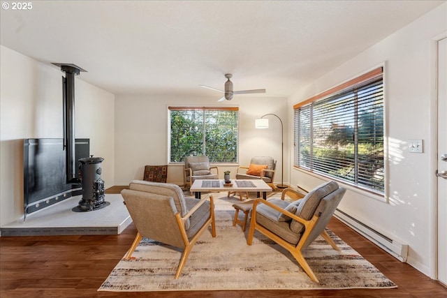 living room featuring ceiling fan, dark hardwood / wood-style floors, and a baseboard radiator