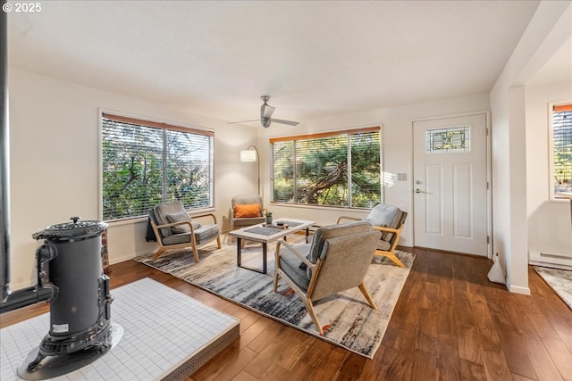 living room with ceiling fan, dark hardwood / wood-style flooring, and a baseboard radiator