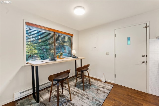 office featuring a baseboard heating unit and dark wood-type flooring