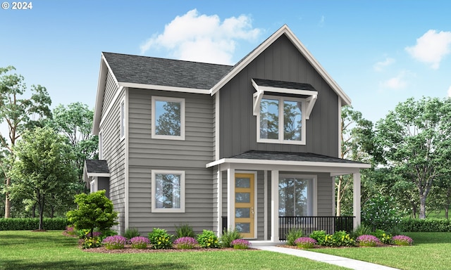 view of front facade with board and batten siding, a front yard, and covered porch