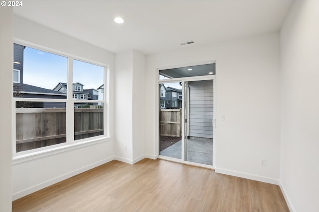 spare room with light wood-style flooring, visible vents, baseboards, and recessed lighting