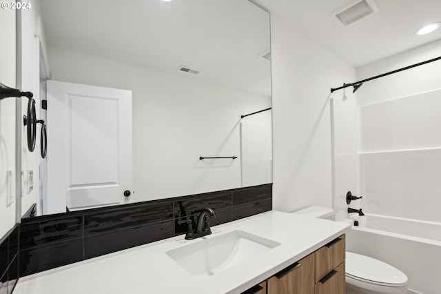 bathroom with toilet,  shower combination, vanity, and visible vents