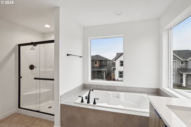 bathroom with recessed lighting, a garden tub, vanity, and a shower stall