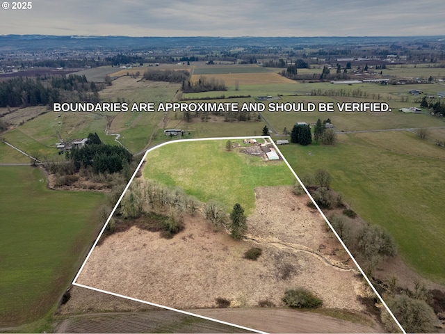 birds eye view of property featuring a rural view