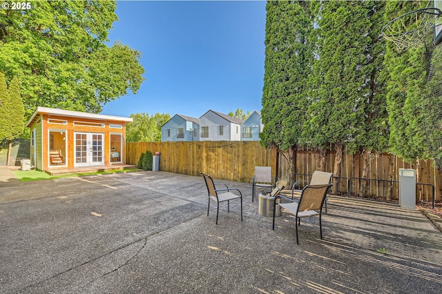 2433 NE Saratoga St, Portland, OR 97211 - view of patio featuring an outbuilding, french doors, and a fenced backyard