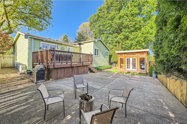 2433 NE Saratoga St, Portland, OR 97211 - exterior space with an outdoor structure, a patio, french doors, and a fenced backyard
