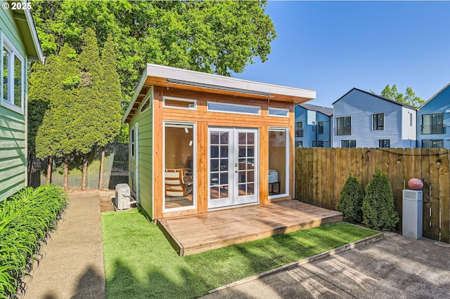 2433 NE Saratoga St, Portland, OR 97211 - view of outdoor structure with a fenced backyard, an outbuilding, and french doors