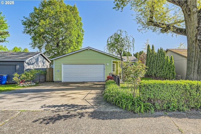 2433 NE Saratoga St, Portland, OR 97211 - view of front of property with fence and a detached garage