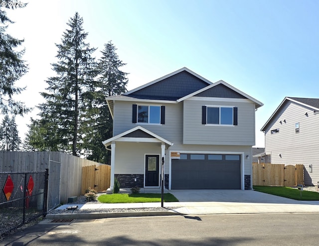 view of front of property featuring fence, concrete driveway, stone siding, and a garage