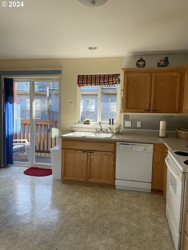 kitchen with sink, white appliances, and decorative backsplash