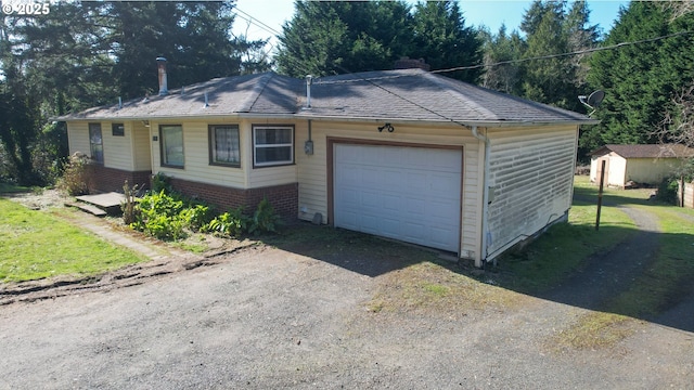 view of front of house featuring driveway, a garage, brick siding, and roof with shingles