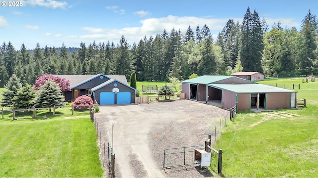 39225 SW Oak Ln, Willamina, OR 97396 - view of front of home with an outdoor structure, dirt driveway, a pole building, a view of trees, and a gate