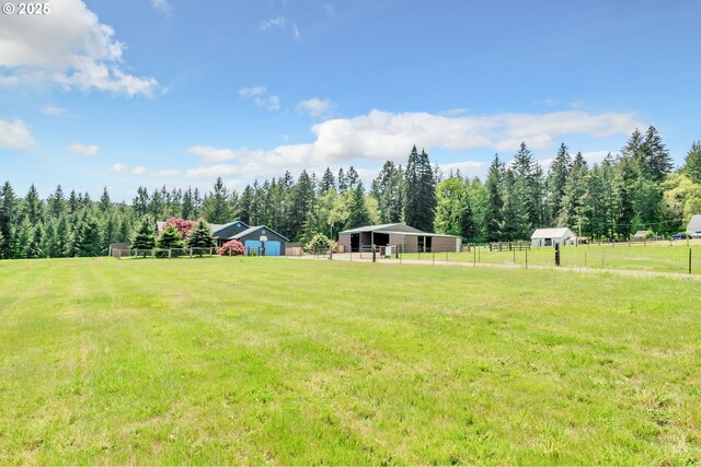 39225 SW Oak Ln, Willamina, OR 97396 - view of yard with an outdoor structure, an outbuilding, and a view of trees